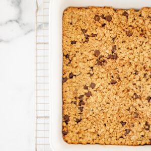 Oatmeal bars in a pan with chocolate chips.