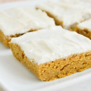Healthy pumpkin bars cut into squares and being served on a plate.