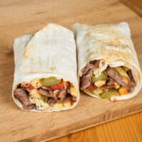 The perfect wrap for lunch or dinner made with chicken, veggies, pesto, and goat cheese.