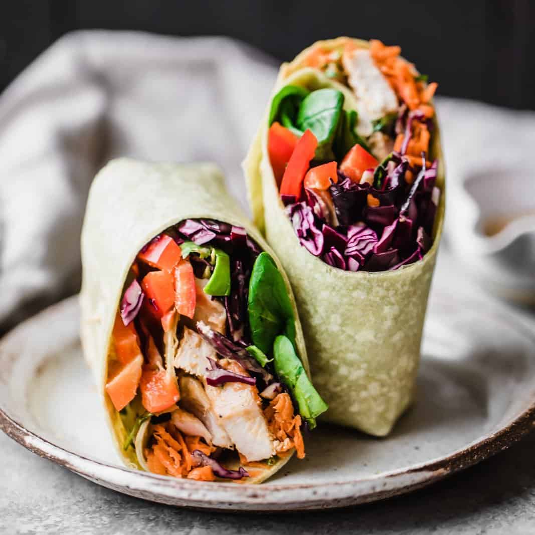 Bright, fresh crunchy rainbow Thai peanut chicken wraps packed with veggies like red cabbage, carrot, spinach and red bell pepper