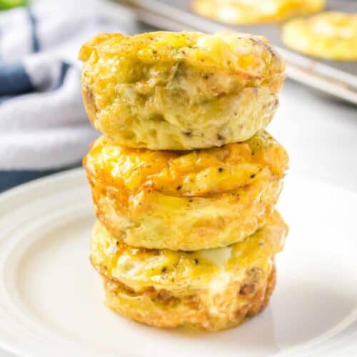 Sausage egg muffins stacked on a plate.