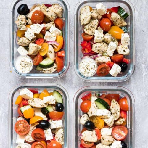 Greek chicken, veggies, and tzatziki sauce in meal prep containers.