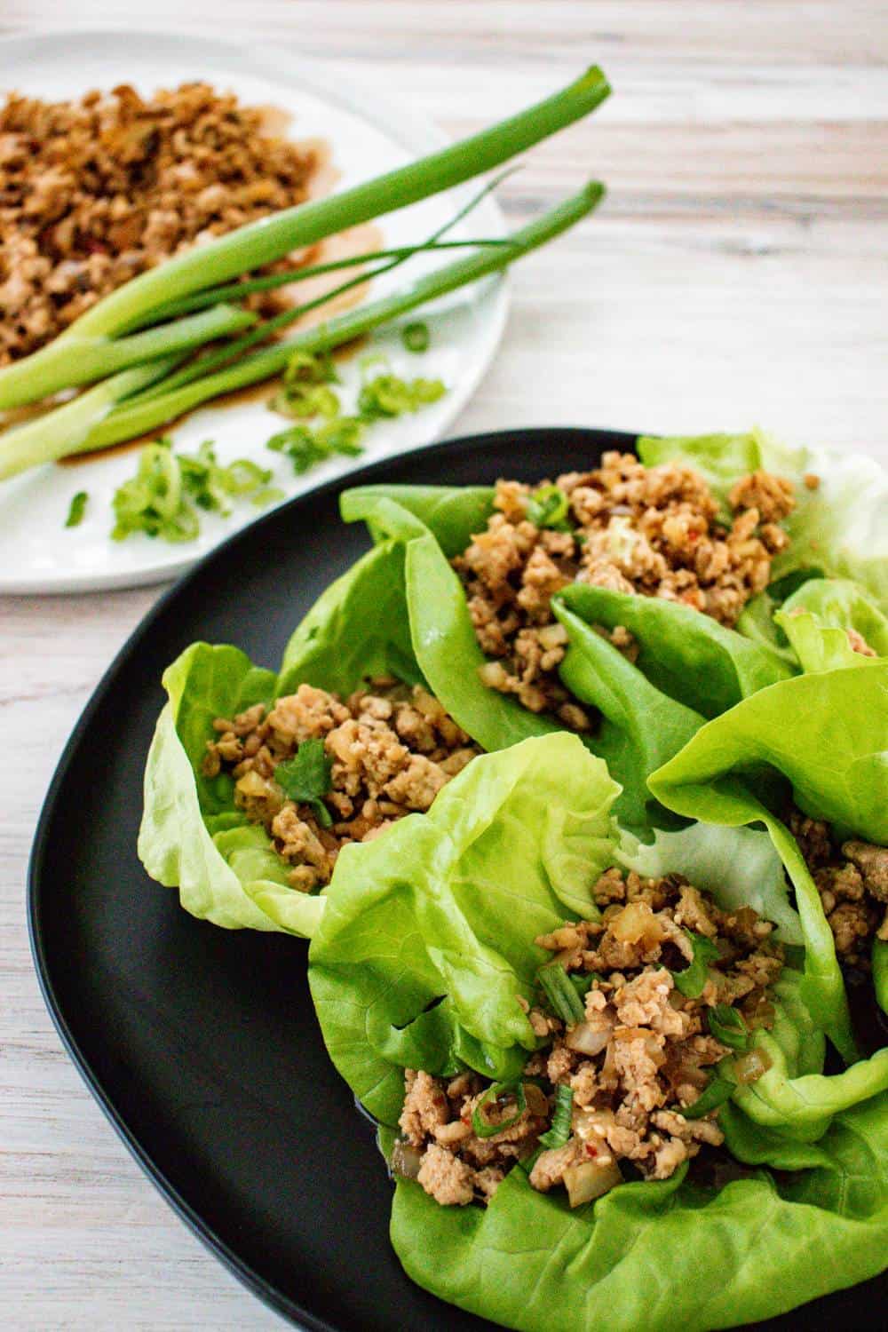 Asian ground chicken mixture nestled into lettuce cups. 