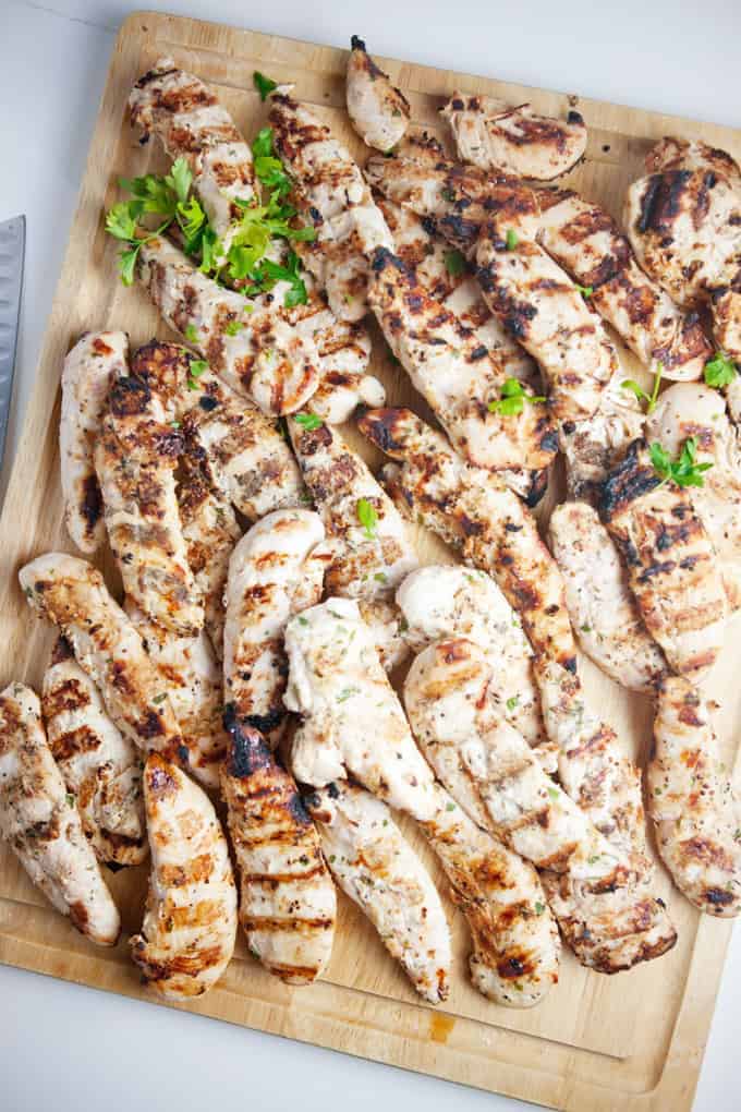 Apple cider grilled chicken on a cutting board. 