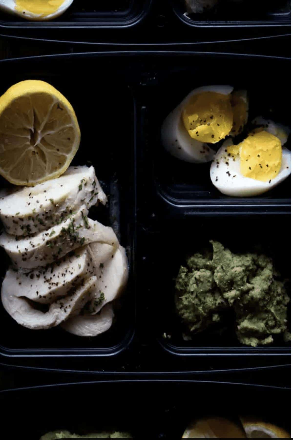 Chicken breast and egg in meal prep containers. 