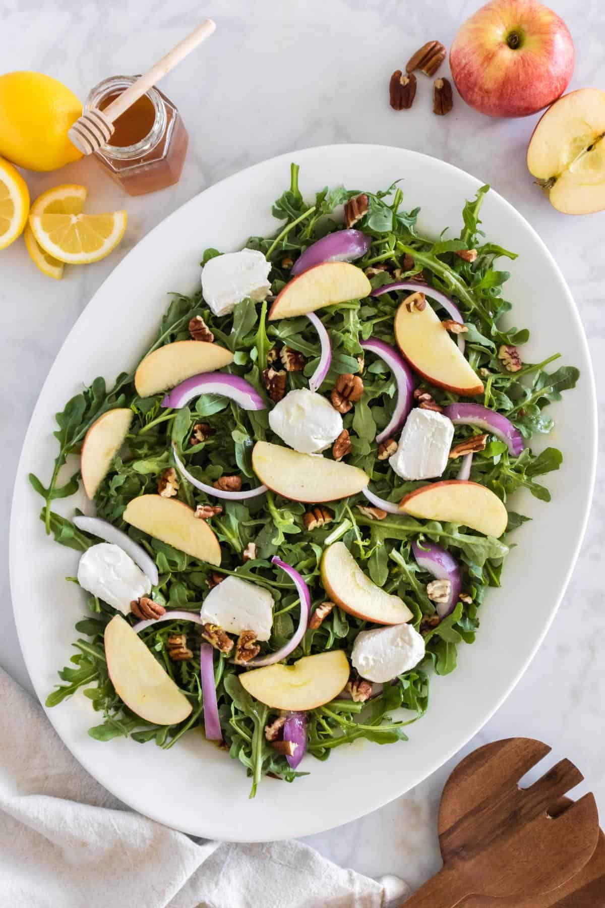 Arugula salad with apples in a large bowl. 