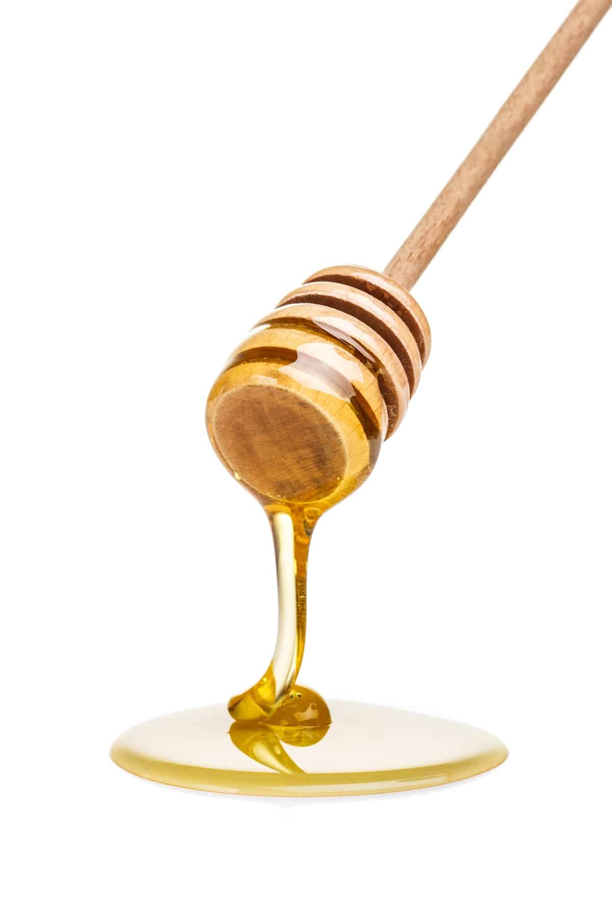 Honey on a wood dipper. 