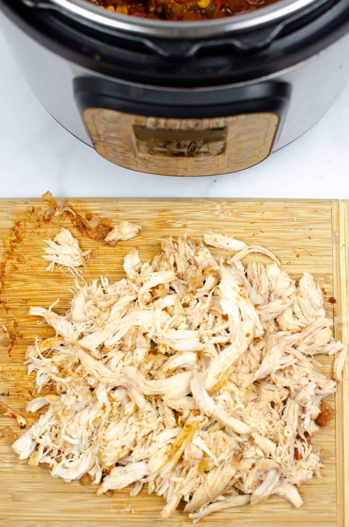 Chicken being shredded for taco soup. 