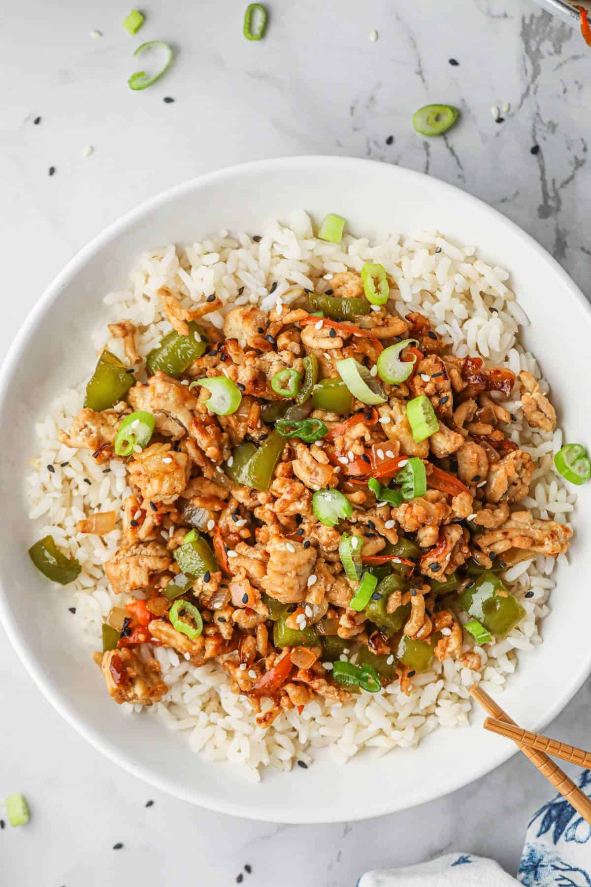 Teriyaki Ground turkey being served over rice in a bowl. 