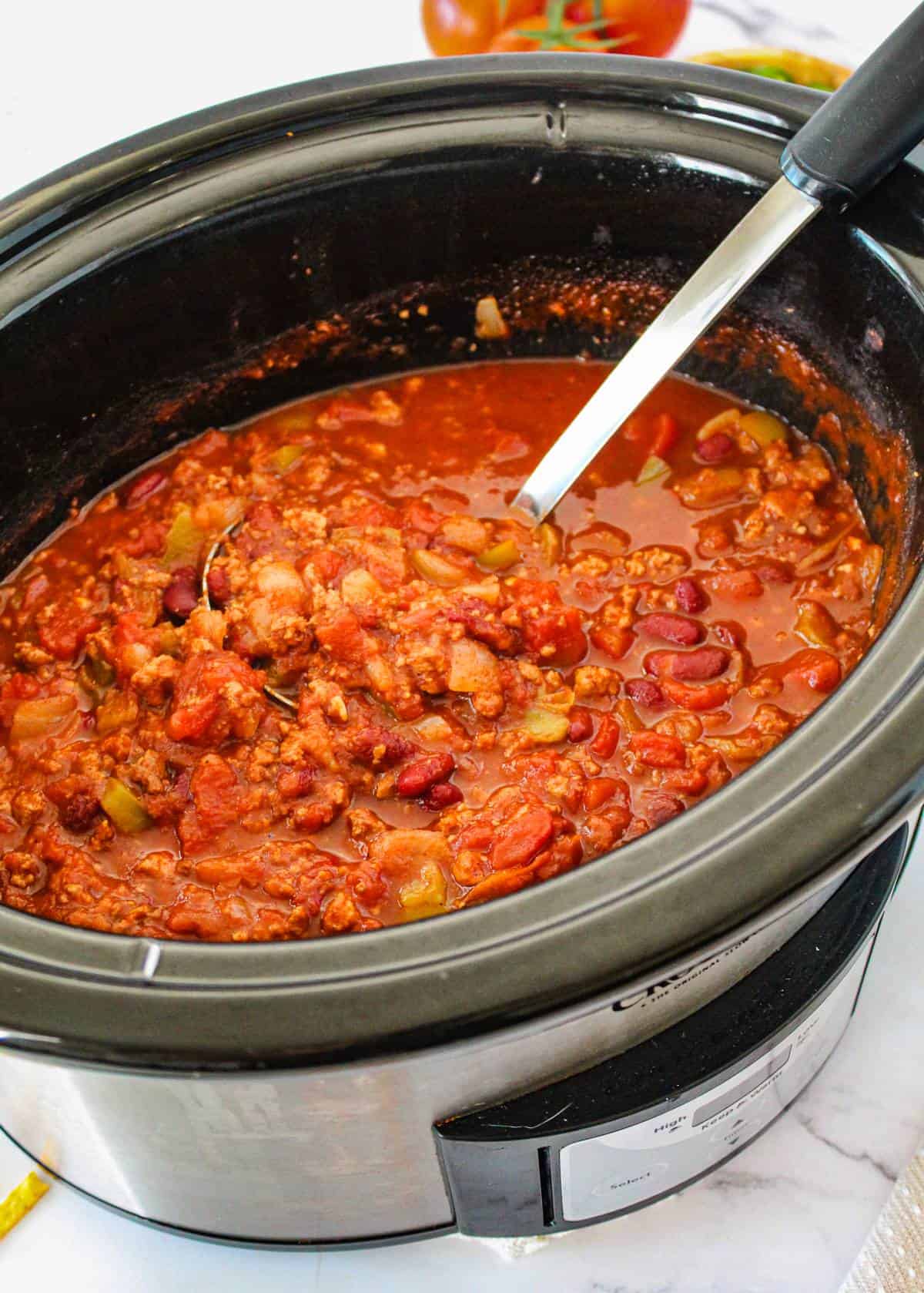 Turkey chili being served out of crockpot. 