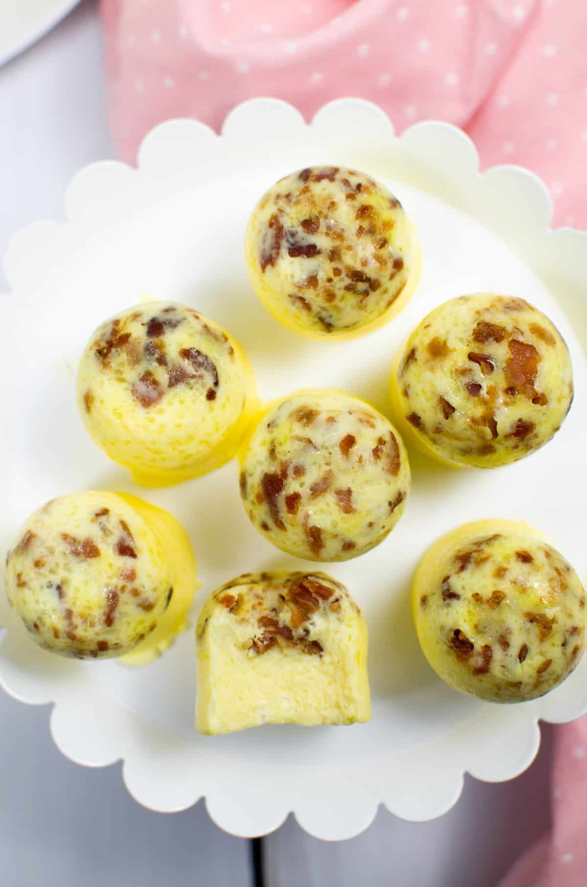 Bacon and Gruyere Egg Bites arranged on a white plate. 
