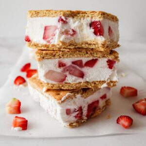 Strawberry ice cream sandwiches stacked on top of each other.