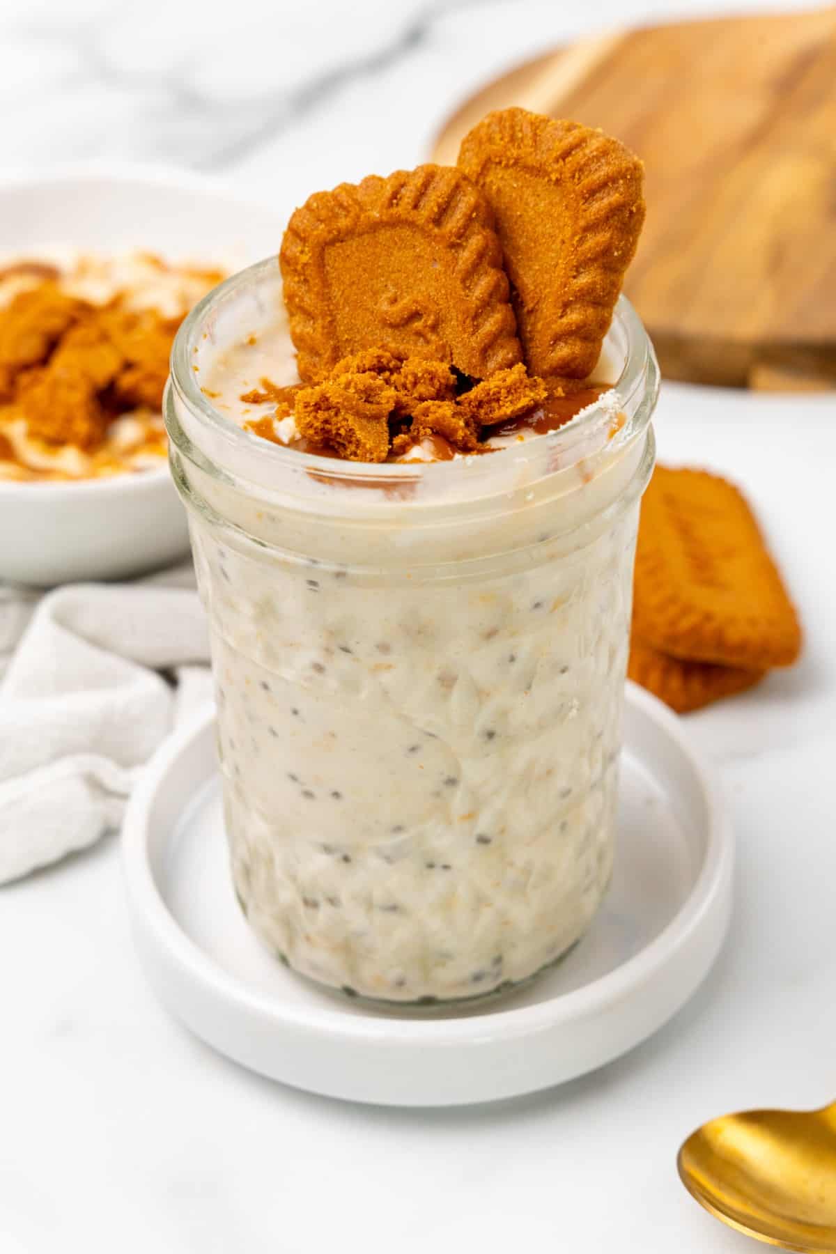 Overnight oats in a mason jar with biscoff spread and crushed biscoff on top. 