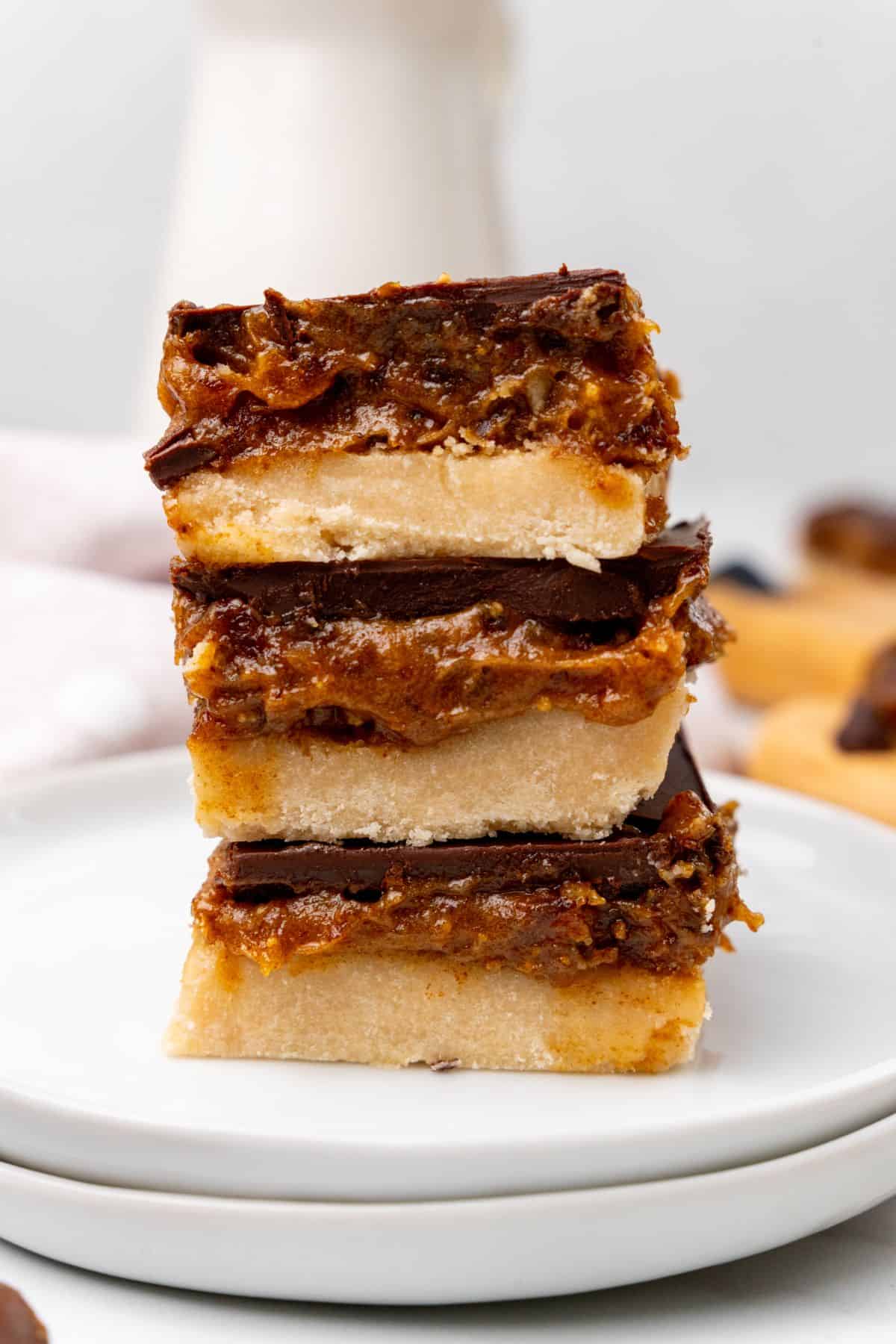 Millionaire bars stacked together on white plate. 