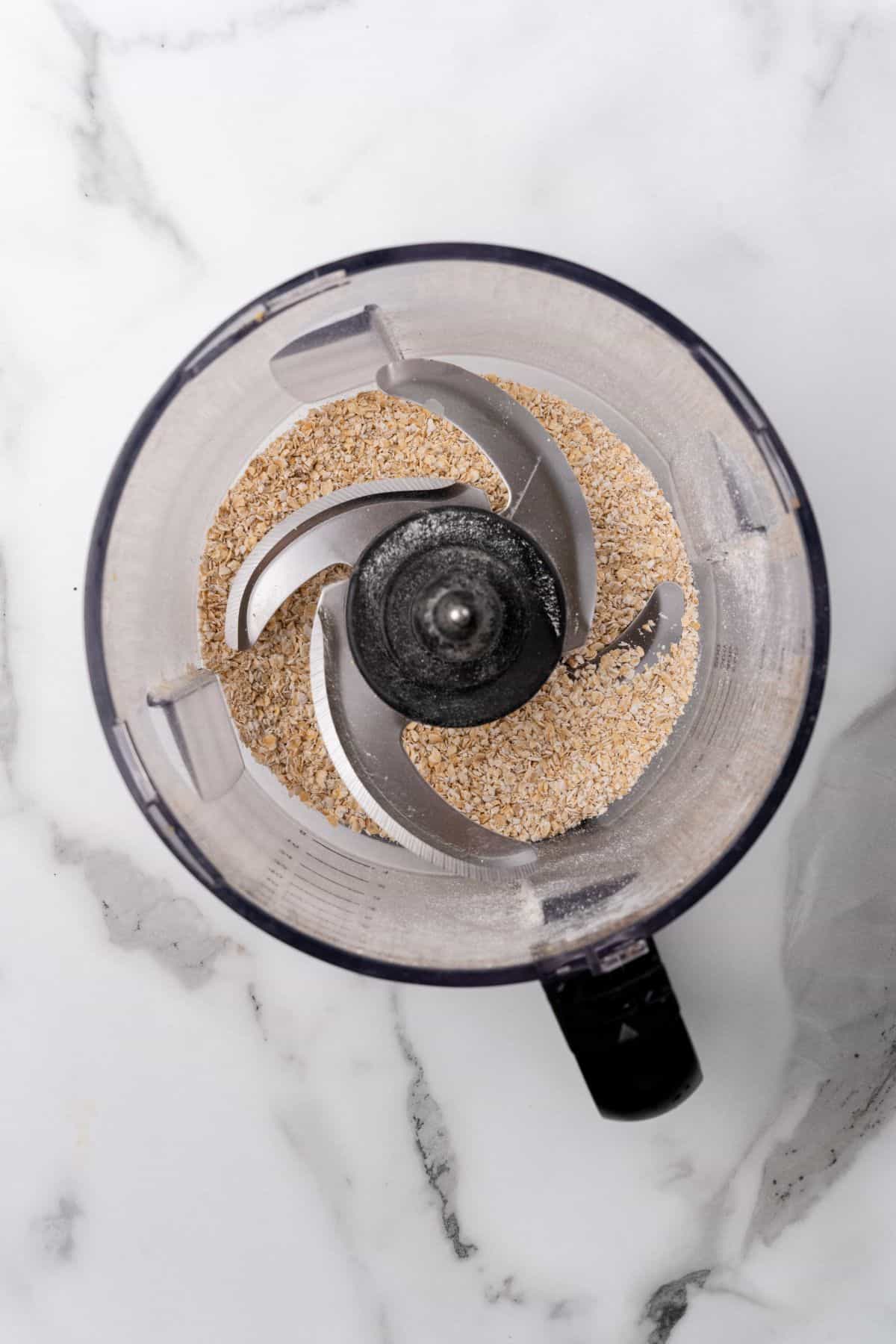 Oats being blended down into a fine powder in a blender. 