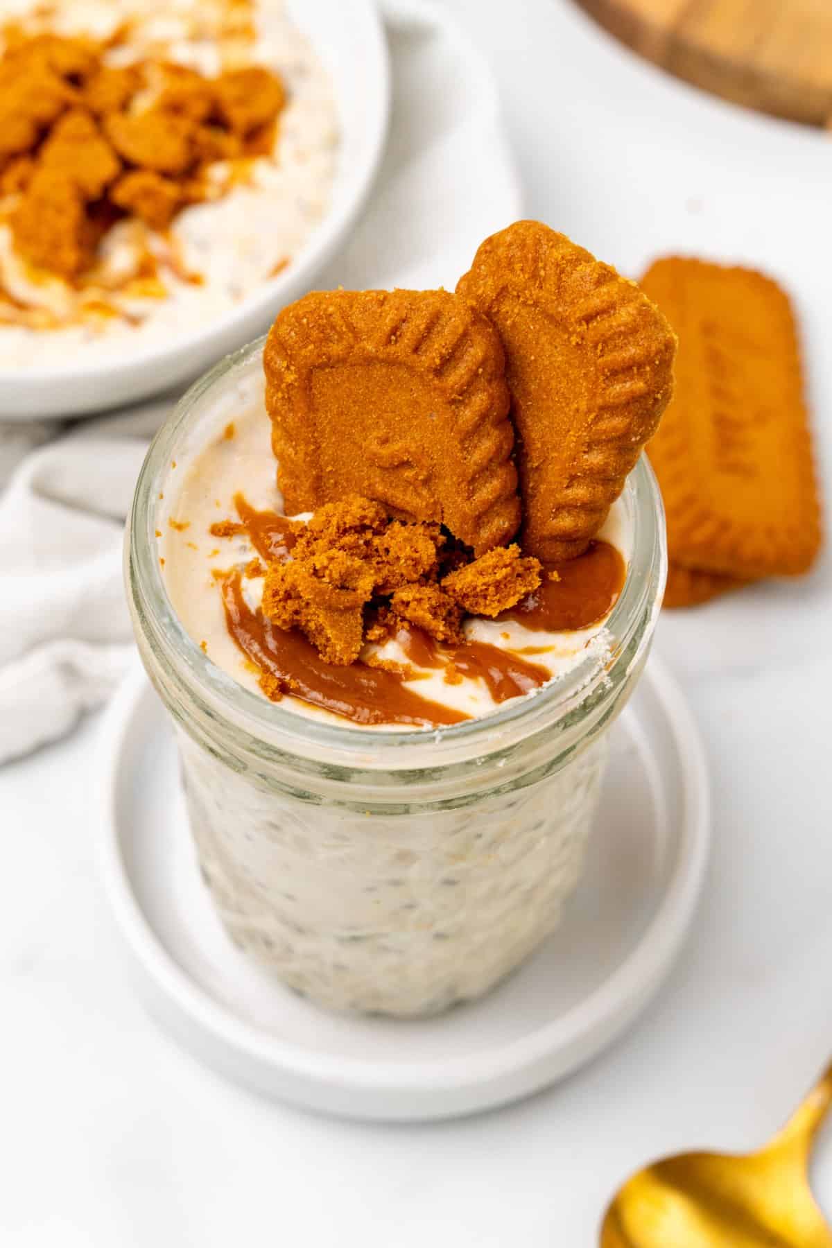 Overnight oats in a mason jar with crushed lotus cookies and lotus biscoff spread. 