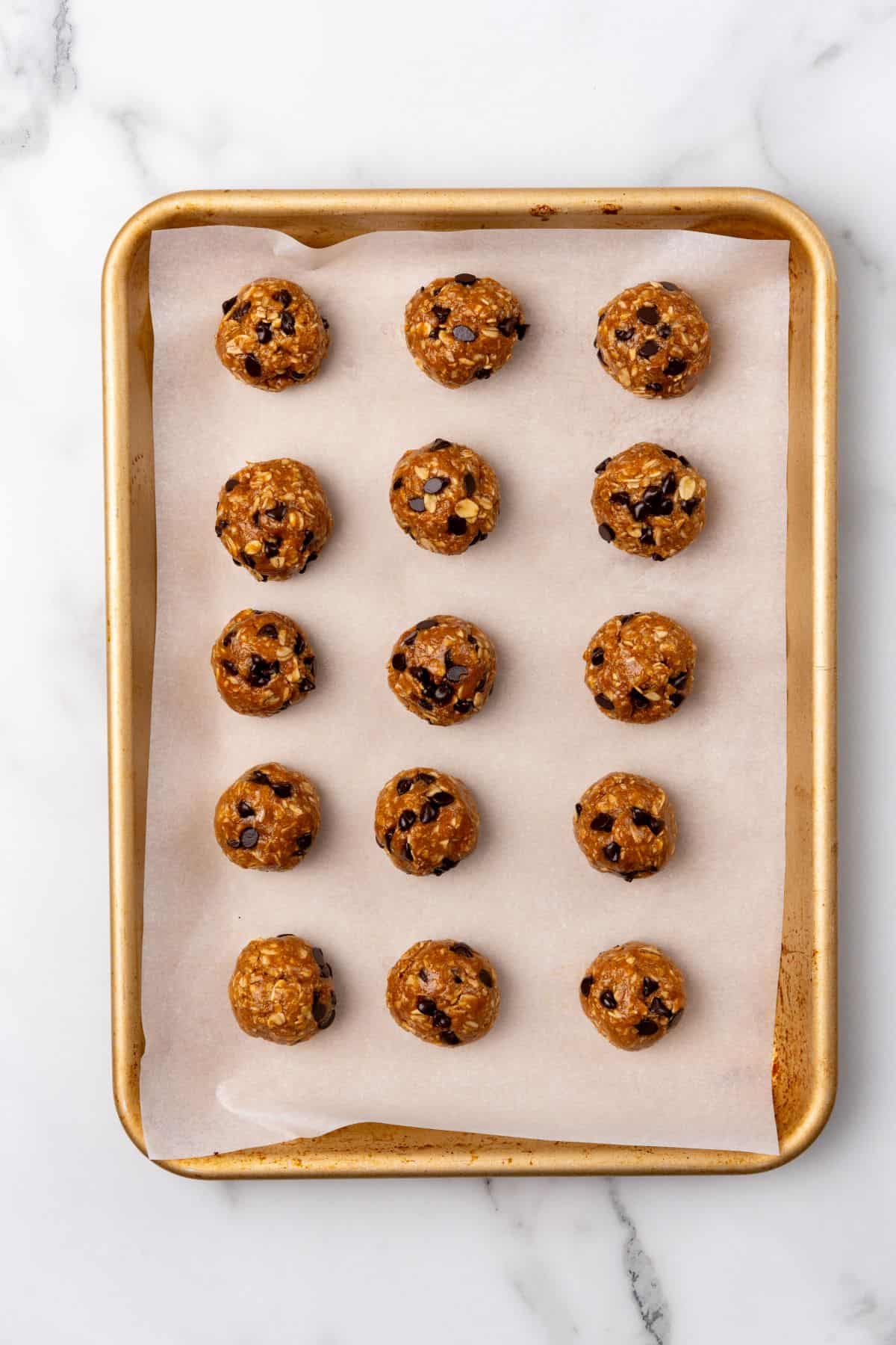 Biscoff protein cookie dough balls on a baking sheet.