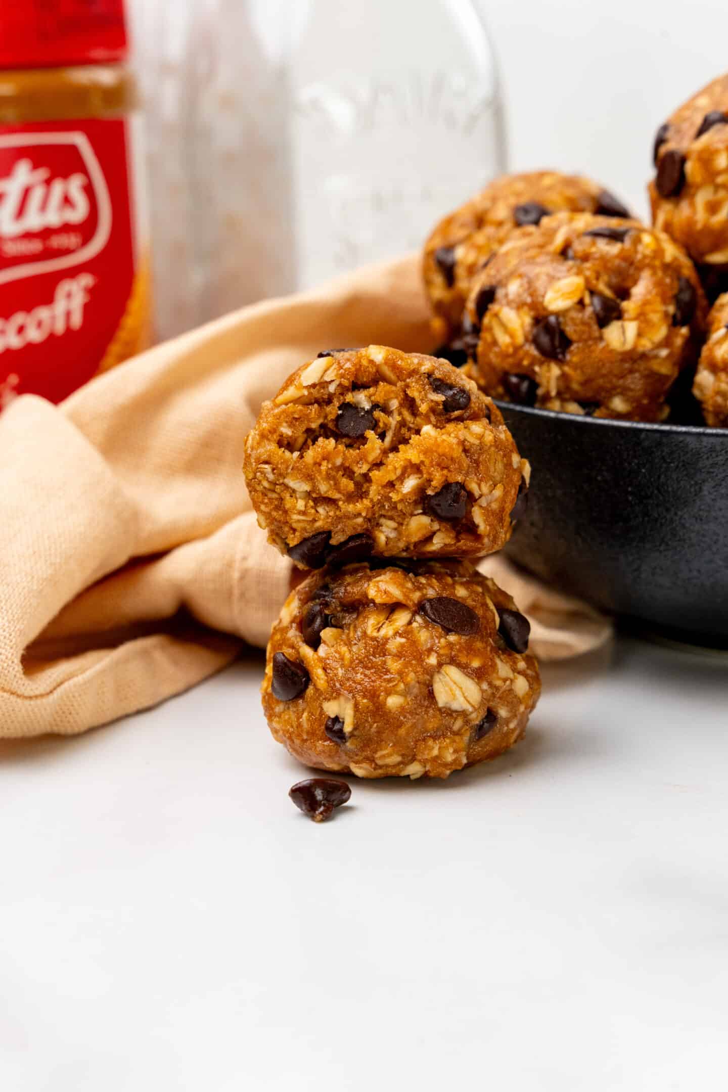 Biscoff protein balls with chocolate chip stacked on top of each other. 