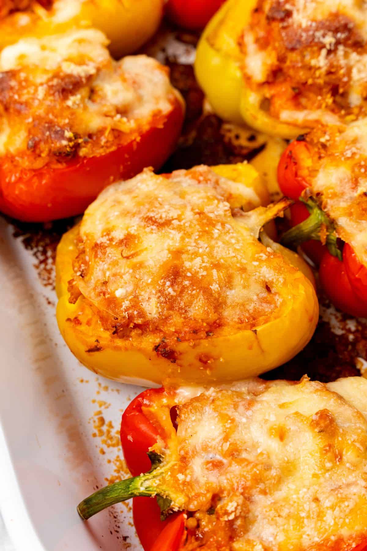 Ground chicken stuffed peppers in a white baking dish.