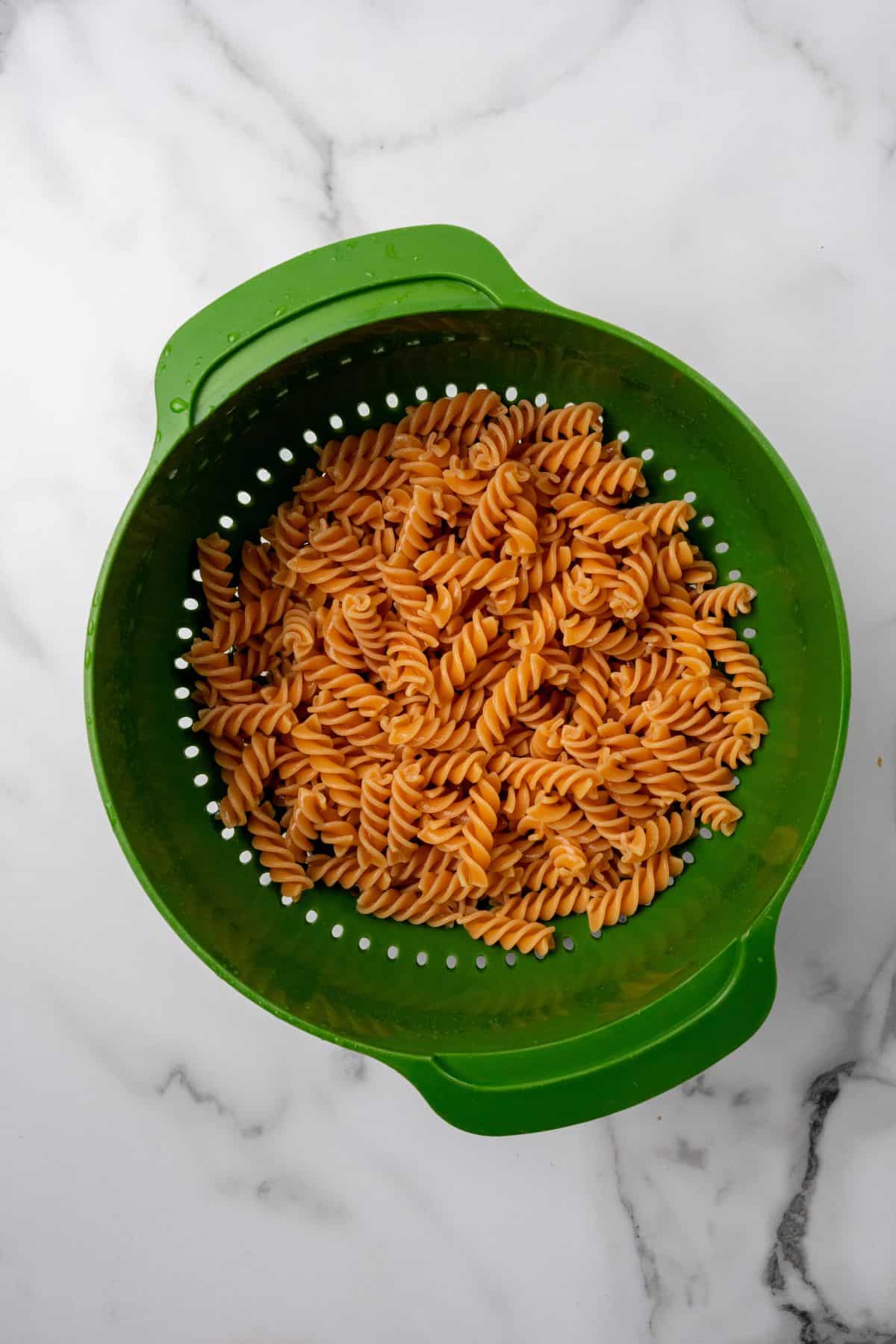 A colander filled with pasta. 