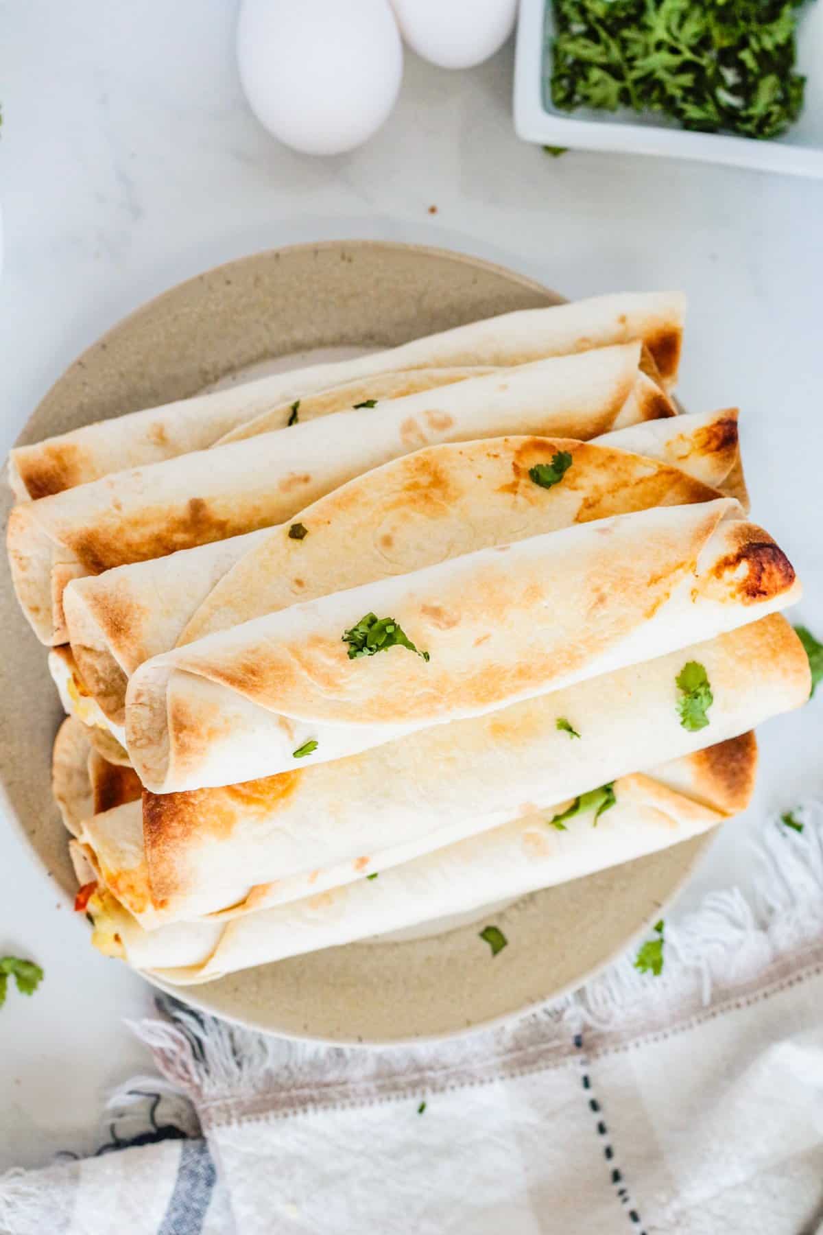 Breakfast taquitos with eggs and cilantro.