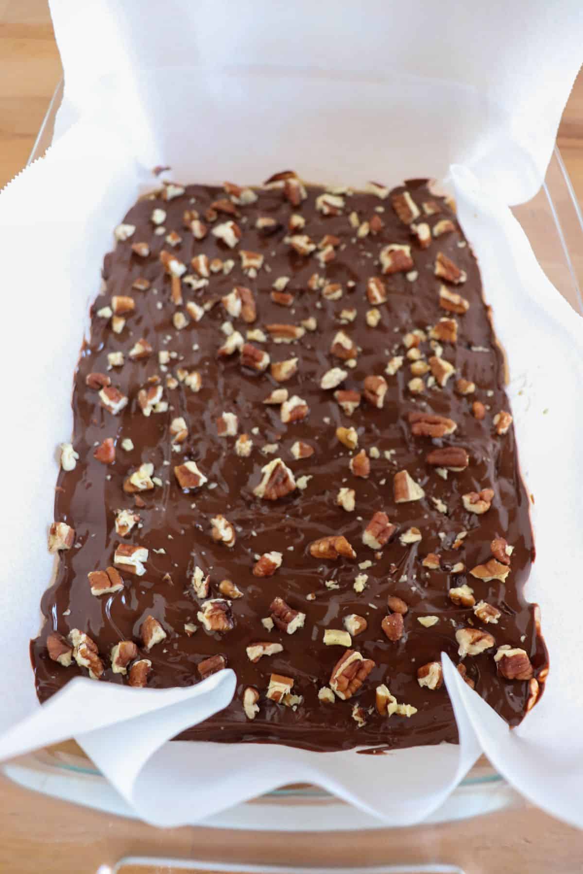 Keto Christmas Crack with pecans in a glass dish.