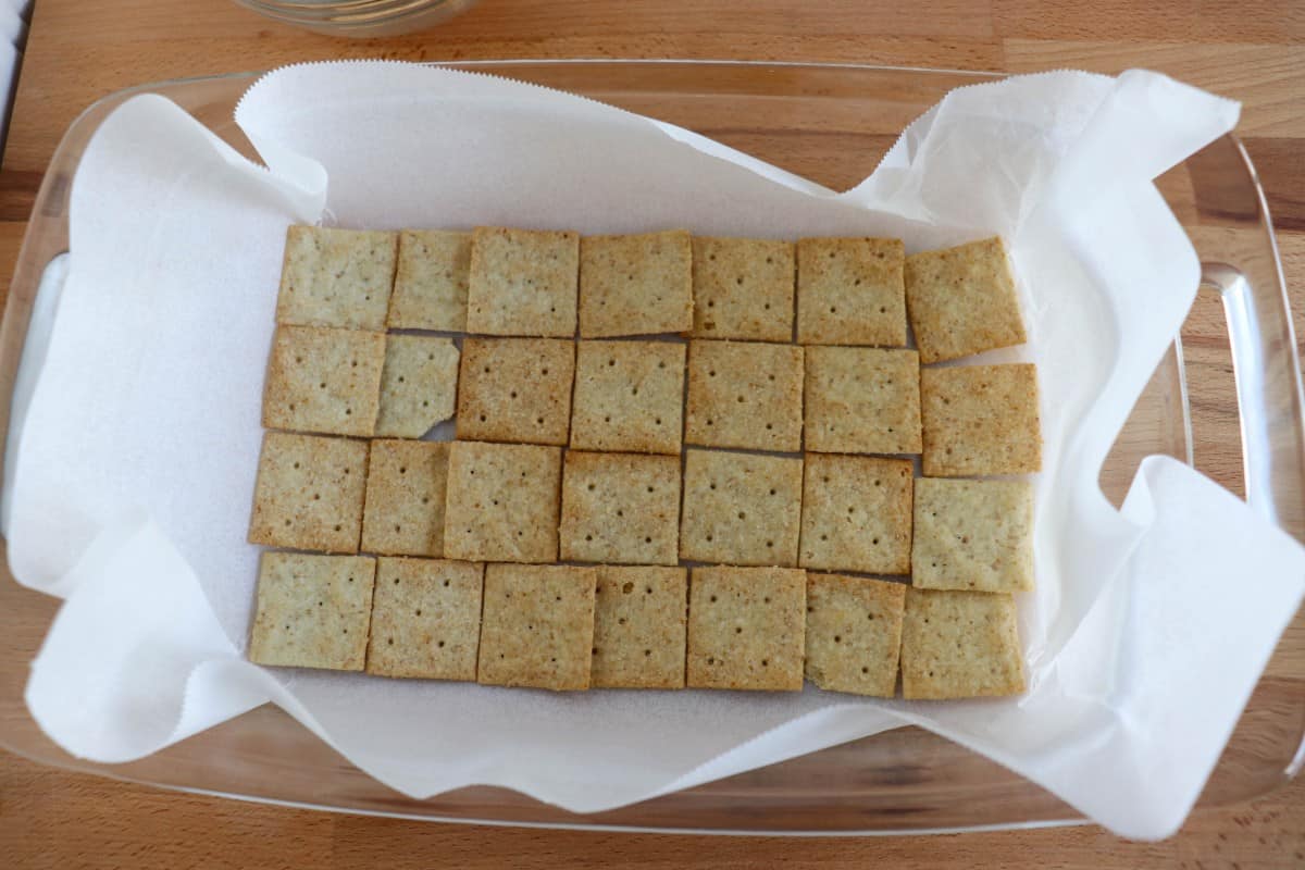 Keto crackers in a baking dish with parchment paper. 