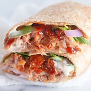 Bbq chicken wrap on a white plate.
