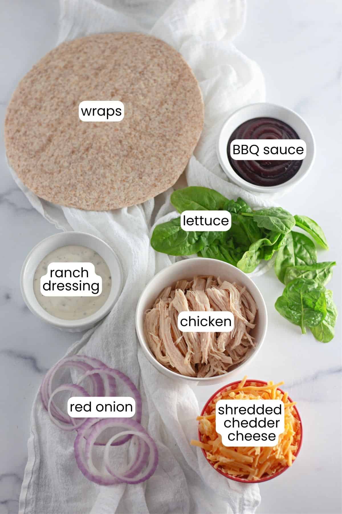 Ingredients for chicken bbq wrap on a marble countertop/ 