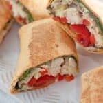 A plate of Chicken Pesto Wraps on a white plate.