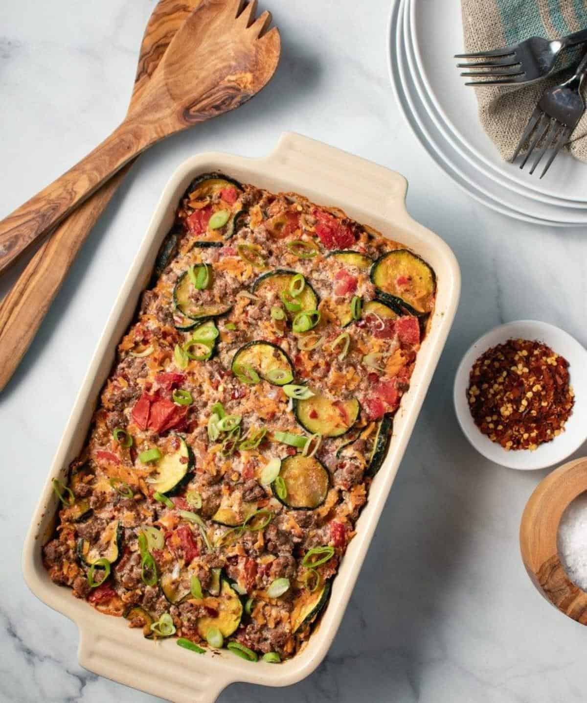 A  casserole dish with vegetables, ground beef, and spices.