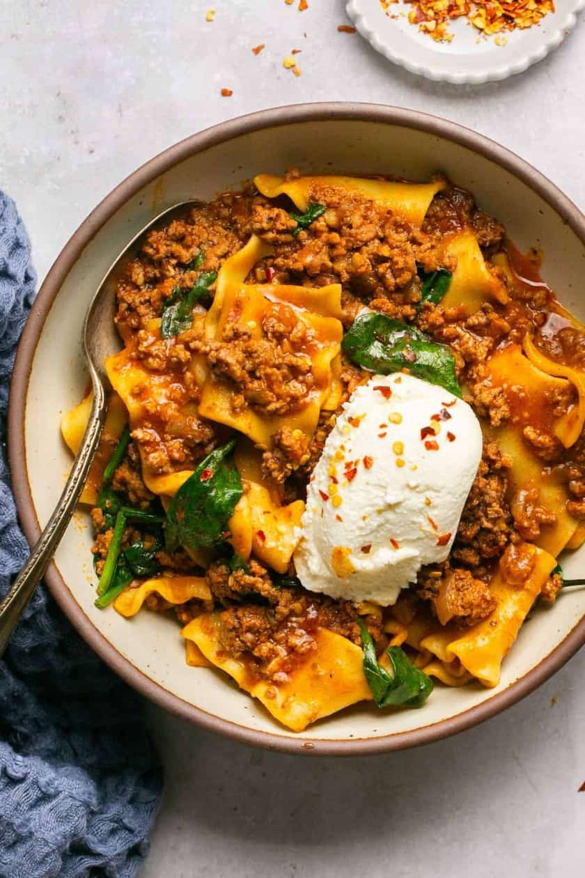Lasagna soup in a bowl with meat, spinach and ricotta cheese.