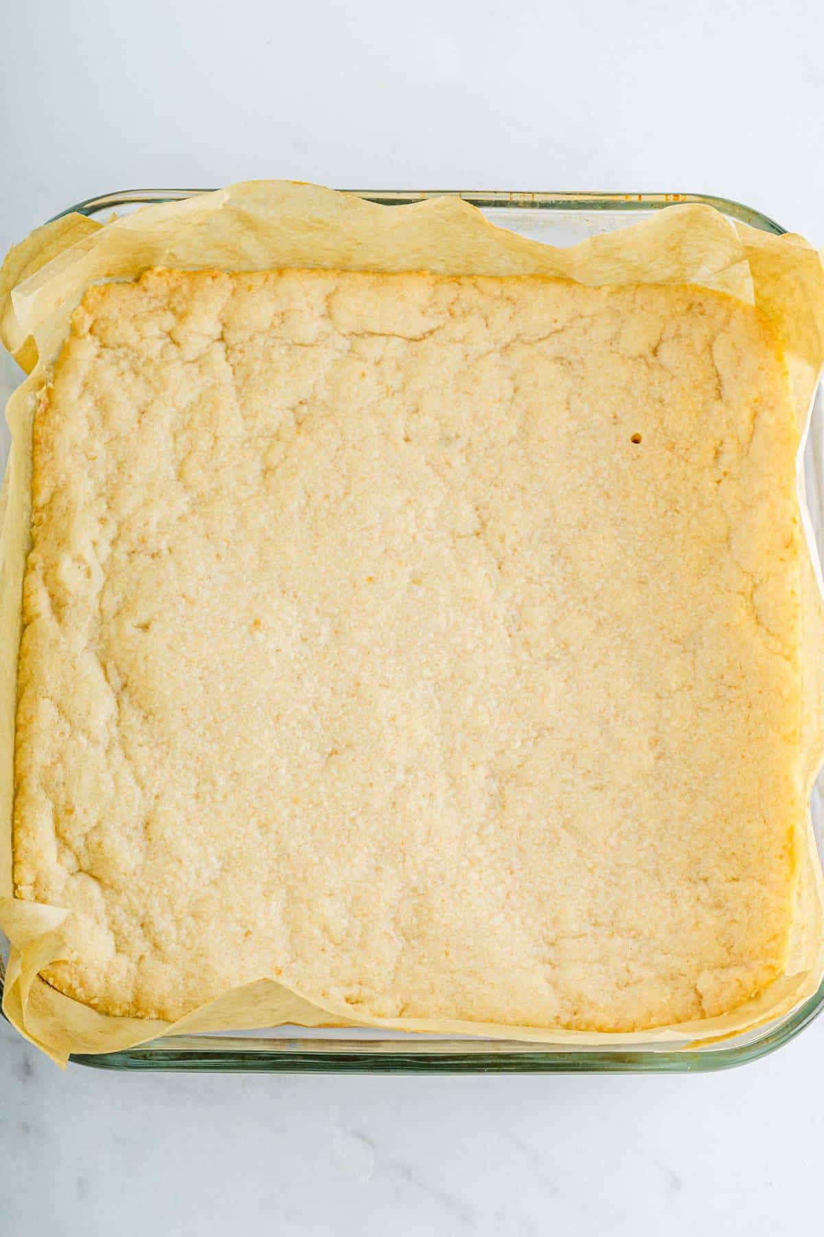 A square of cooked dough in a baking dish. 