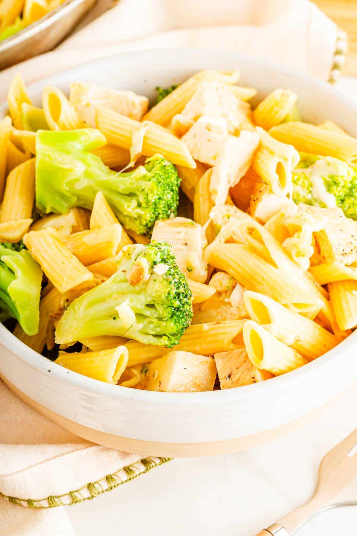 A penne pasta dish with tender chicken and fresh broccoli.