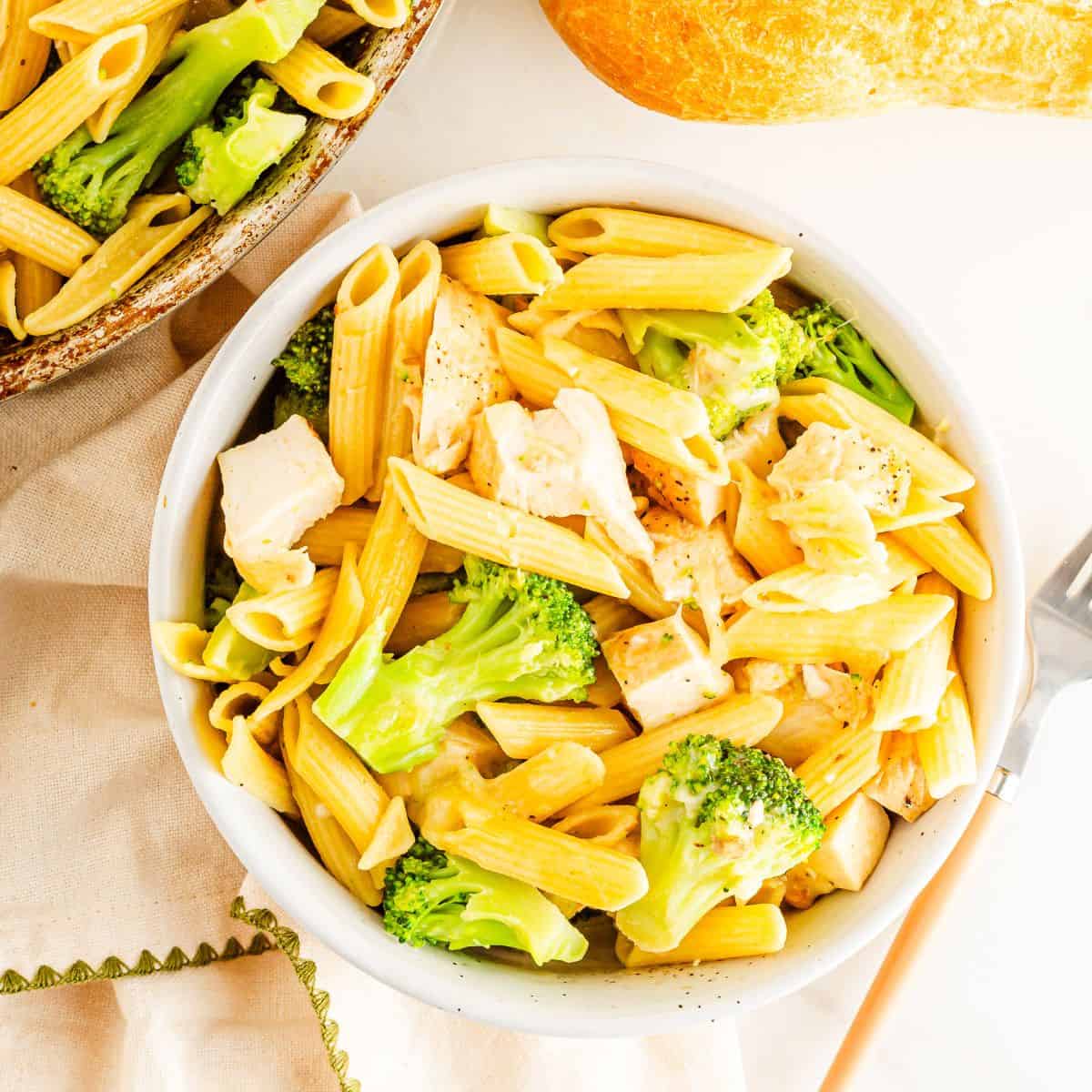 A bowl of Penne pasta with chicken and broccoli.