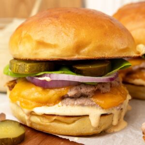 A Smash turkey Burger with cheese and pickles.