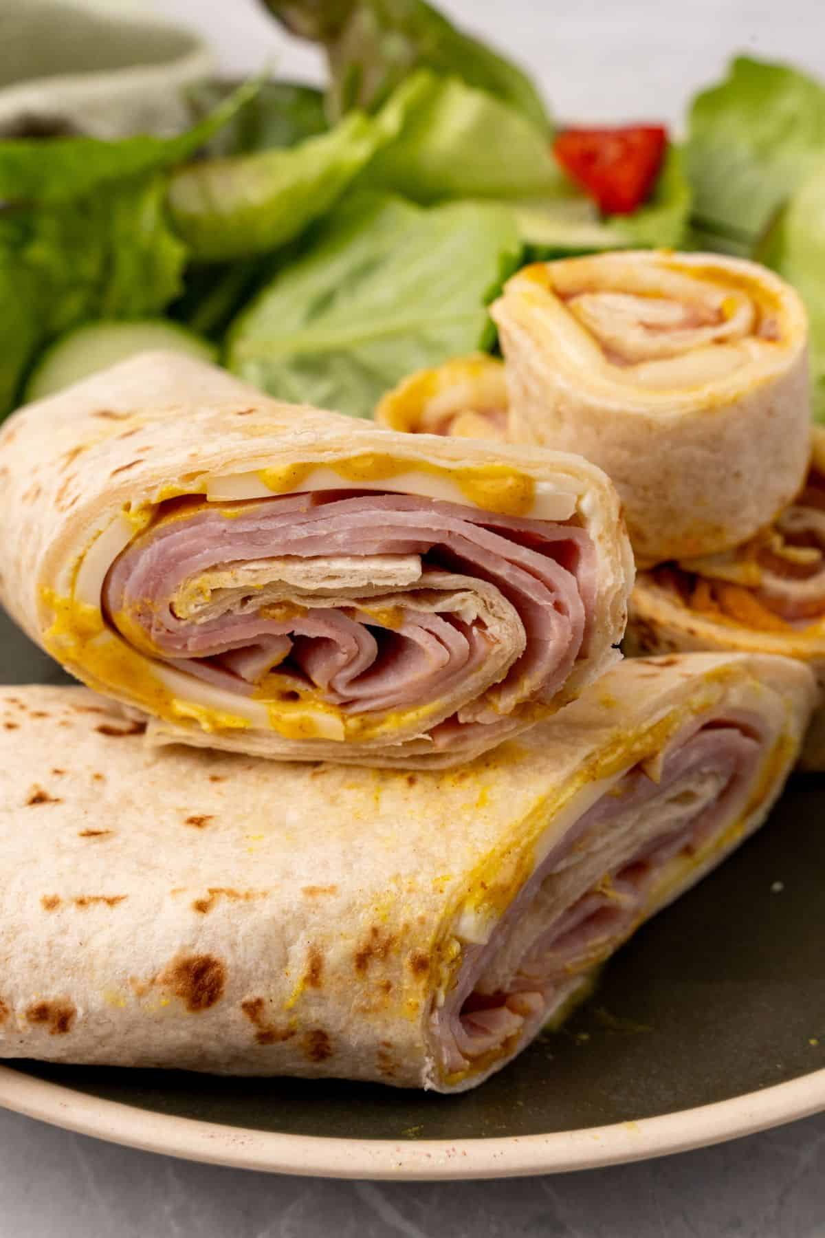 A close up of cheese and ham wraps.