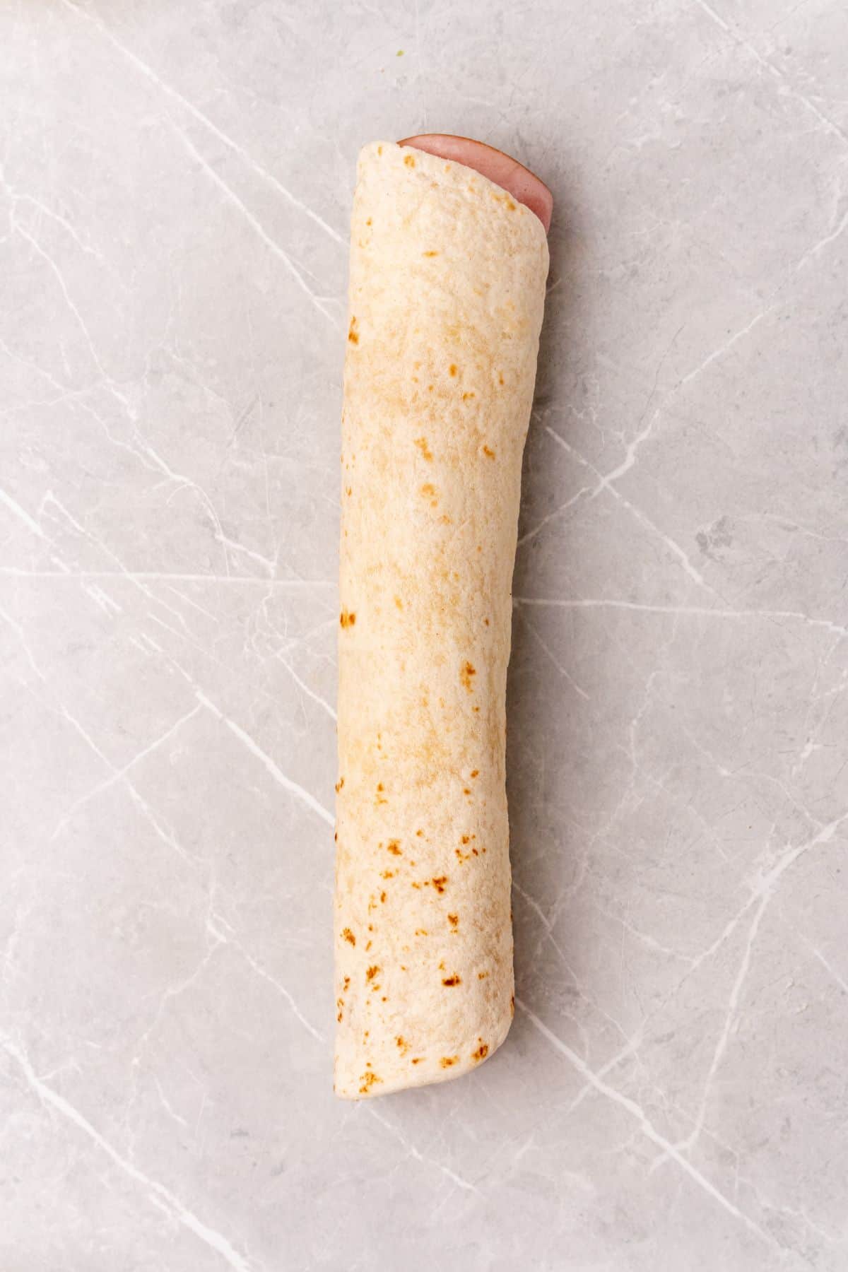 A hot dog wrapped in a tortilla, also known as a "wrap.