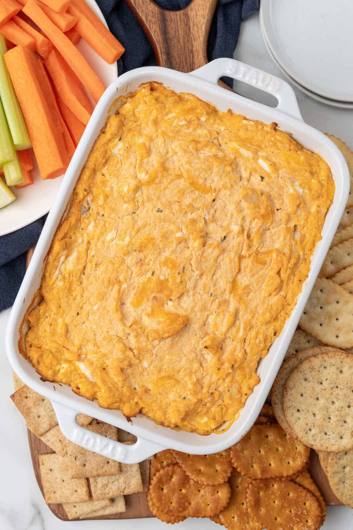 Creamy Buffalo Chicken Dip served with crackers and carrots.