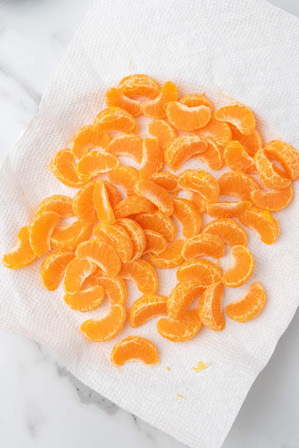 Peeled orange segments on a paper towel. 