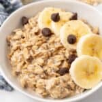 A delightful bowl of overnight oats made with Pb2, topped with sweet banana slices and rich chocolate chips.