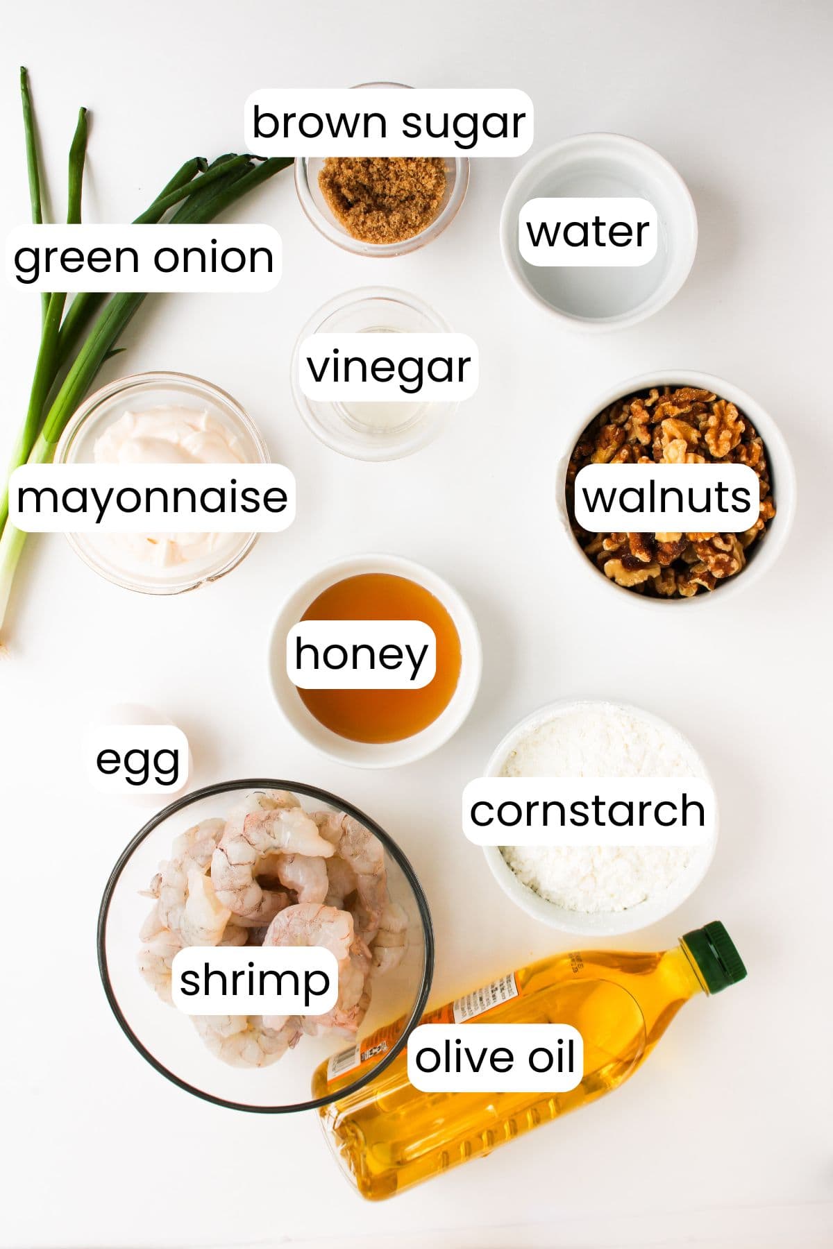 The ingredients for a delectable Honey Walnut Shrimp recipe are spread out: brown sugar, green onion, mayonnaise, egg, shrimp, and more. With the help of your trusty air fryer, olive oil and cornstarch combine effortlessly with honey and vinegar to create a delightful dish.