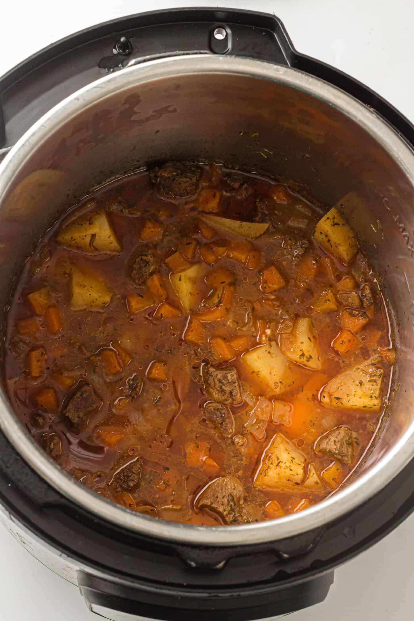 Beef Stew with potatoes and carrots cooked to perfection in an Instant Pot stainless steel electric pressure cooker.