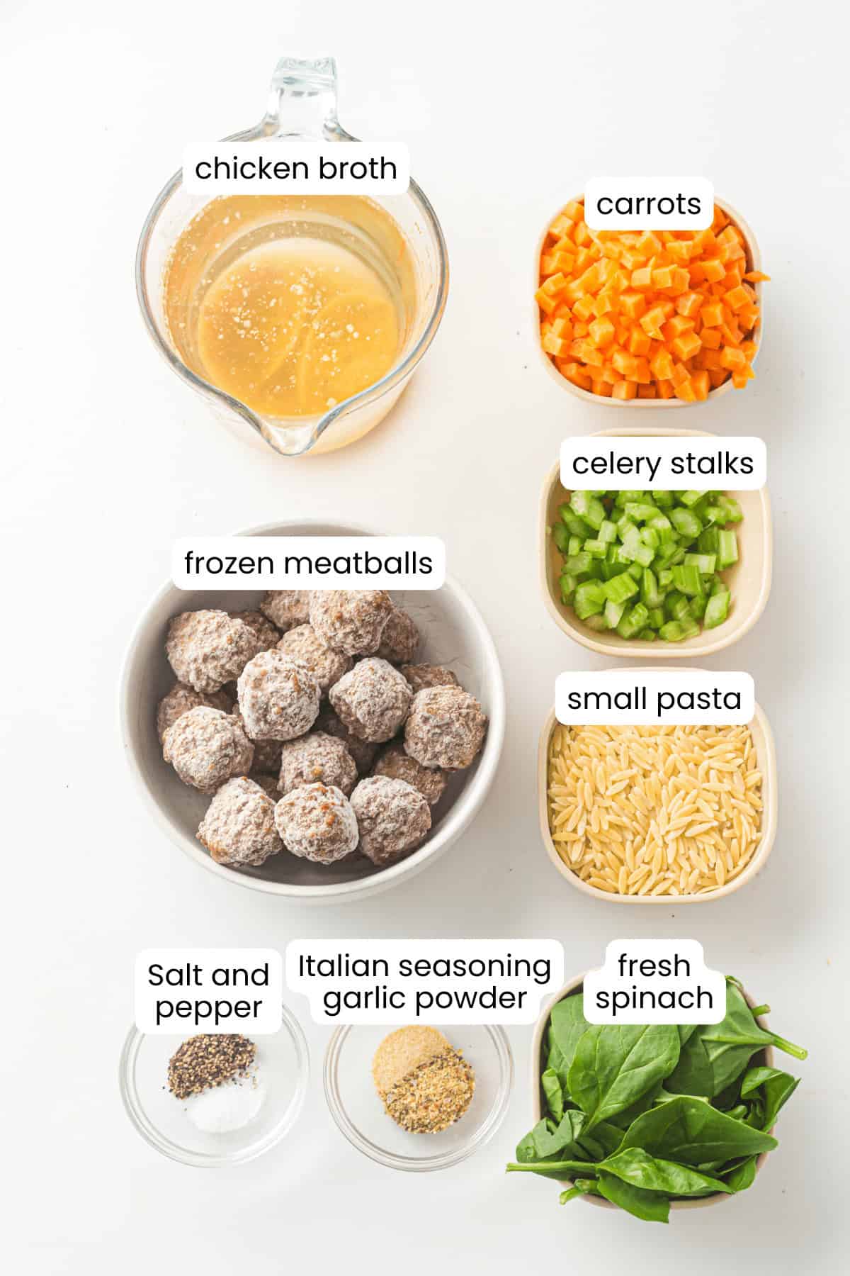 Ingredients for Italian Wedding Soup are laid out, including chicken broth, diced carrots, celery, frozen meatballs, small pasta, fresh spinach, salt, pepper, Italian seasoning, and garlic powder—perfect for a cozy one-pot meal.