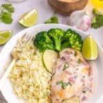Coconut lime chicken served with rice, broccoli, lime, and cilantro.