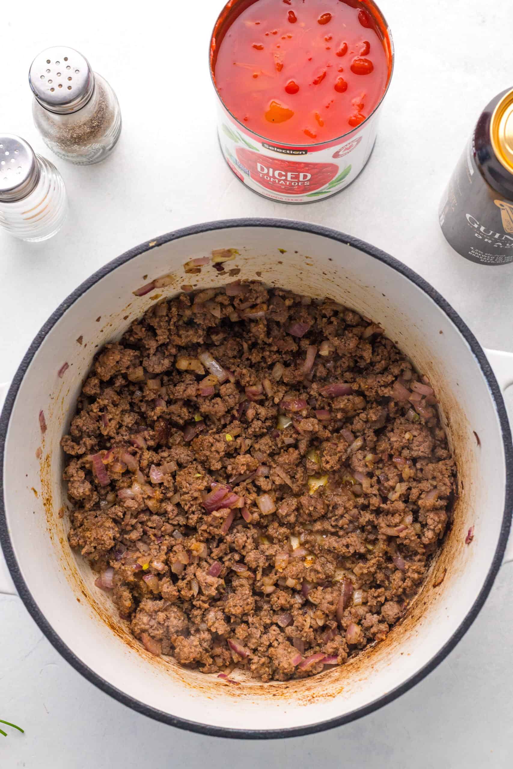 Ground beef and chopped onion browned in a Dutch oven.
