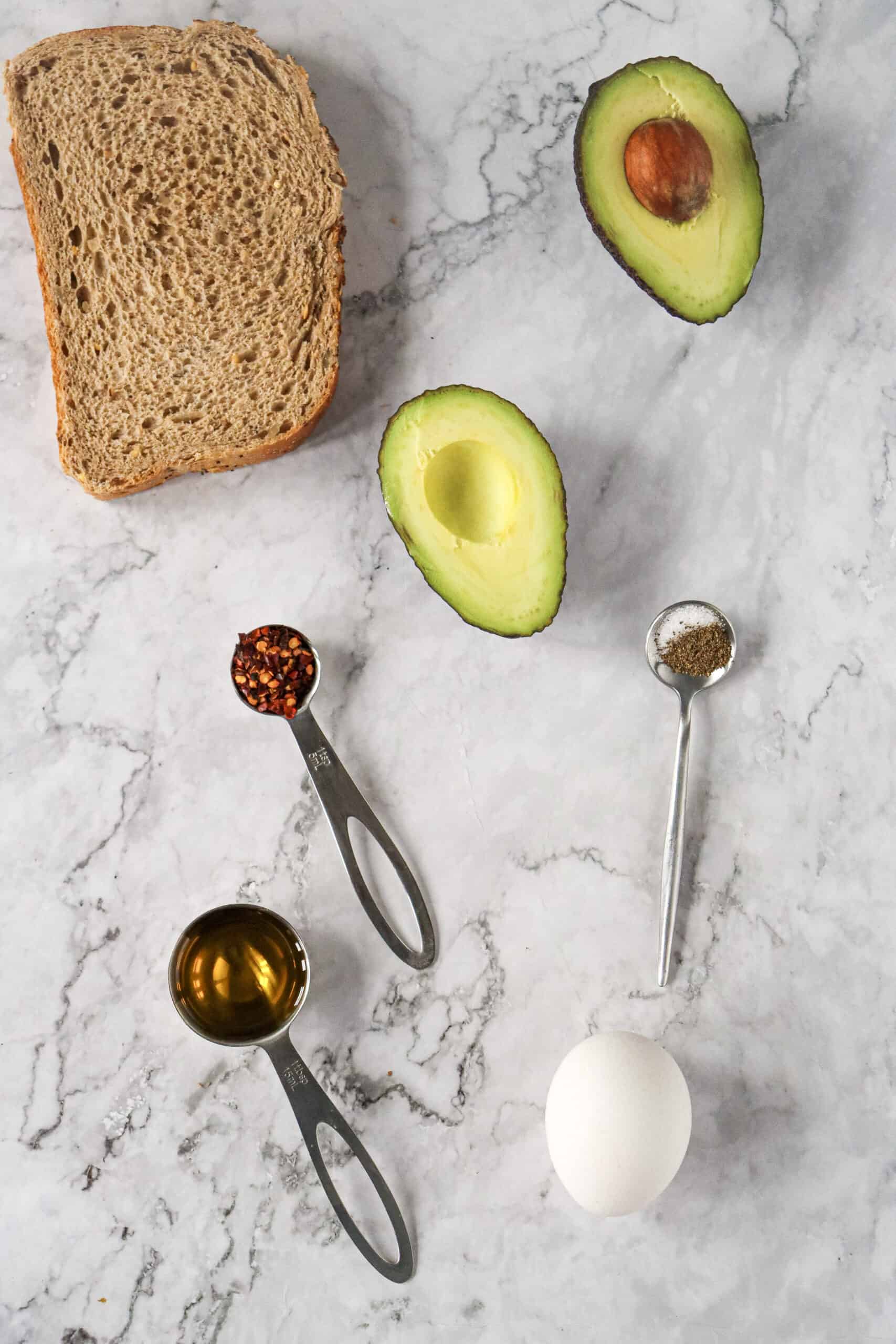 Bread, avocado, hard-boiled egg, olive oil, chili flakes, salt, and pepper.