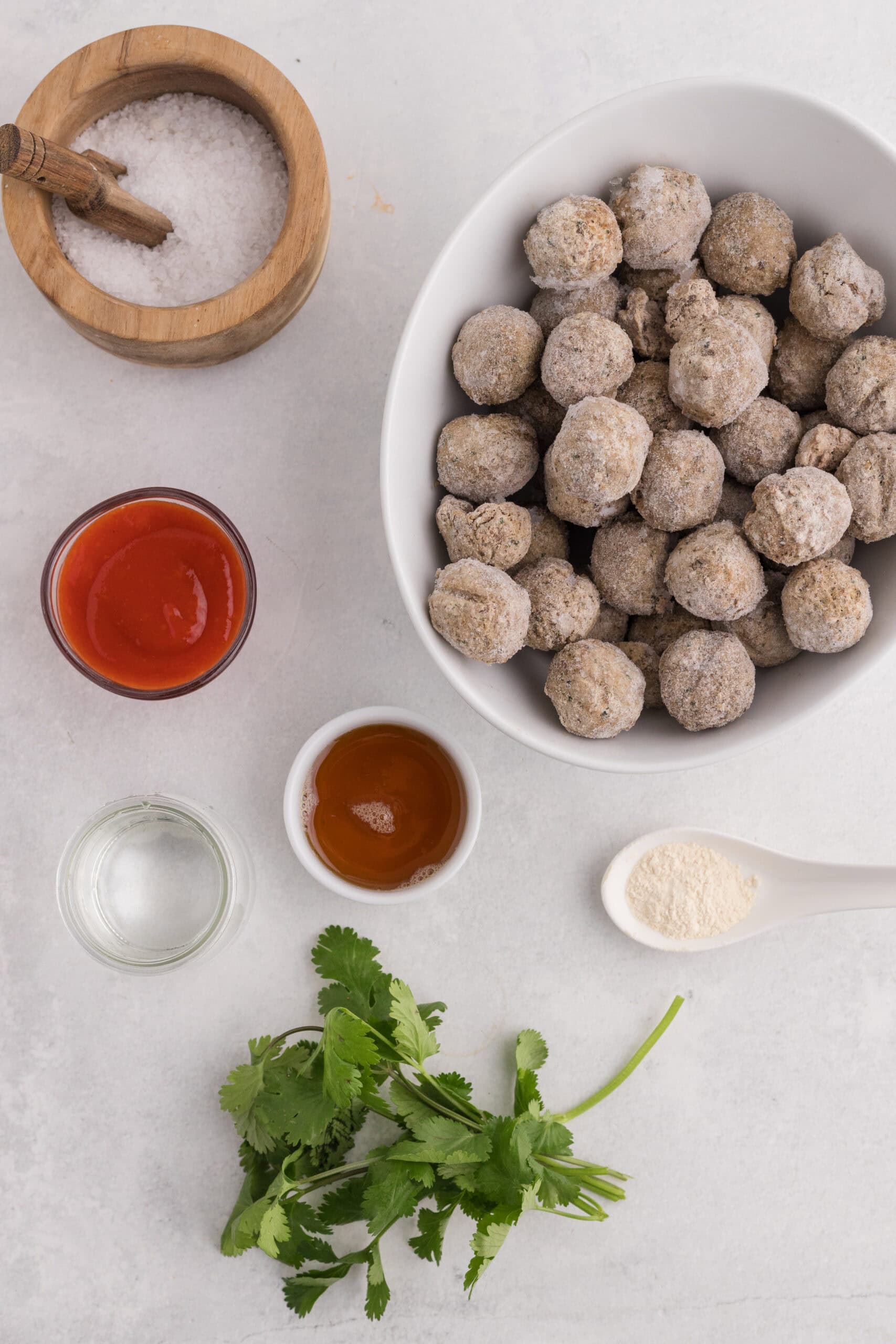 Frozen meatballs, sriracha, maple syrup, garlic powder, water, salt, and cilantro.