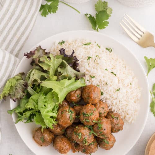 Sriracha meatballs served with rice and greens.