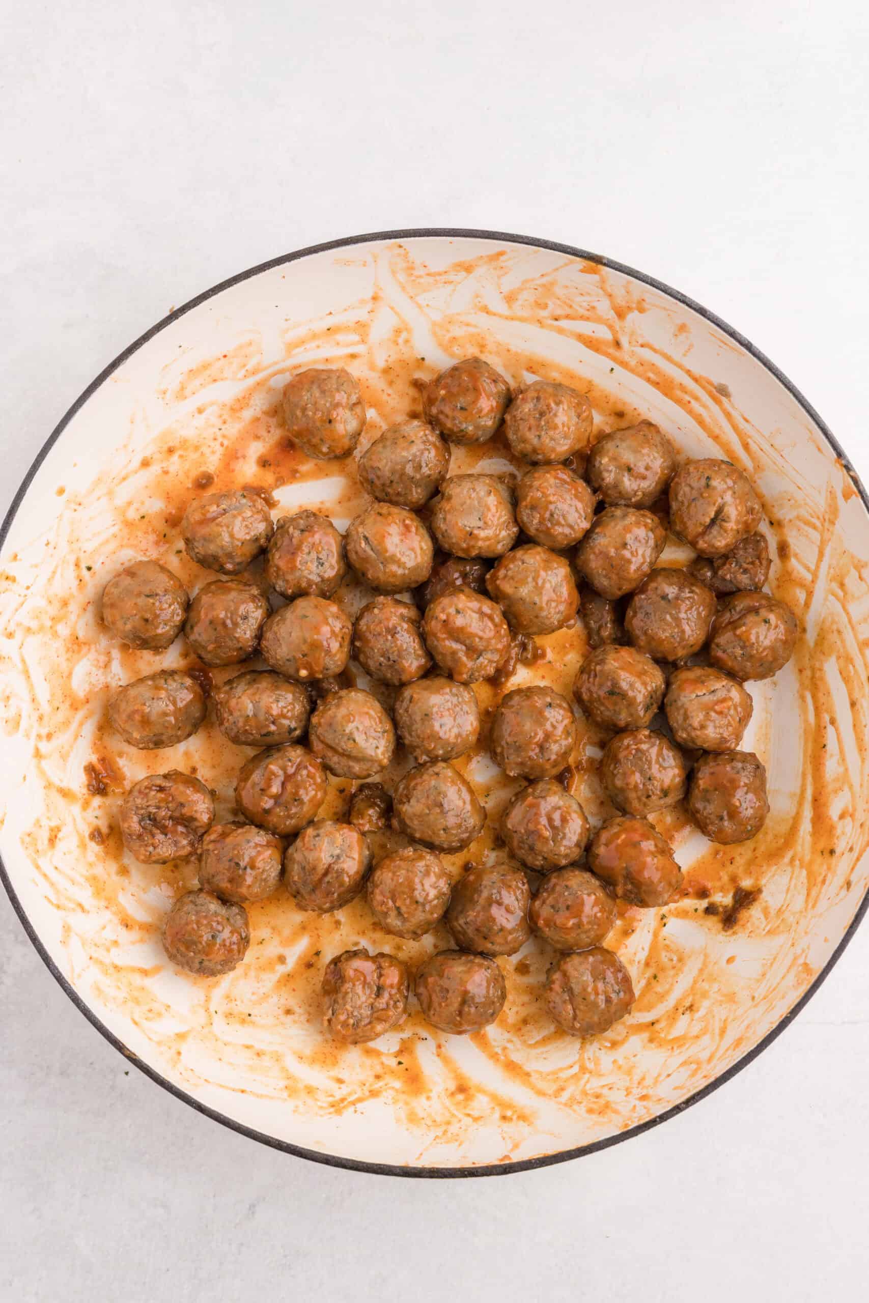 Meatballs coated in a glossy sriracha glaze.
